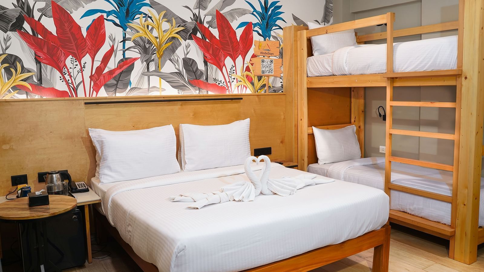 A large bed next to bunk beds in Urban Corner Family Room at Indie Stays Resort, Goa.